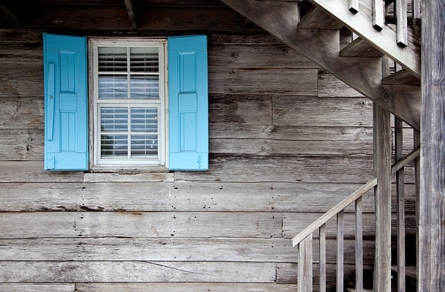 Grey house window blue shutters