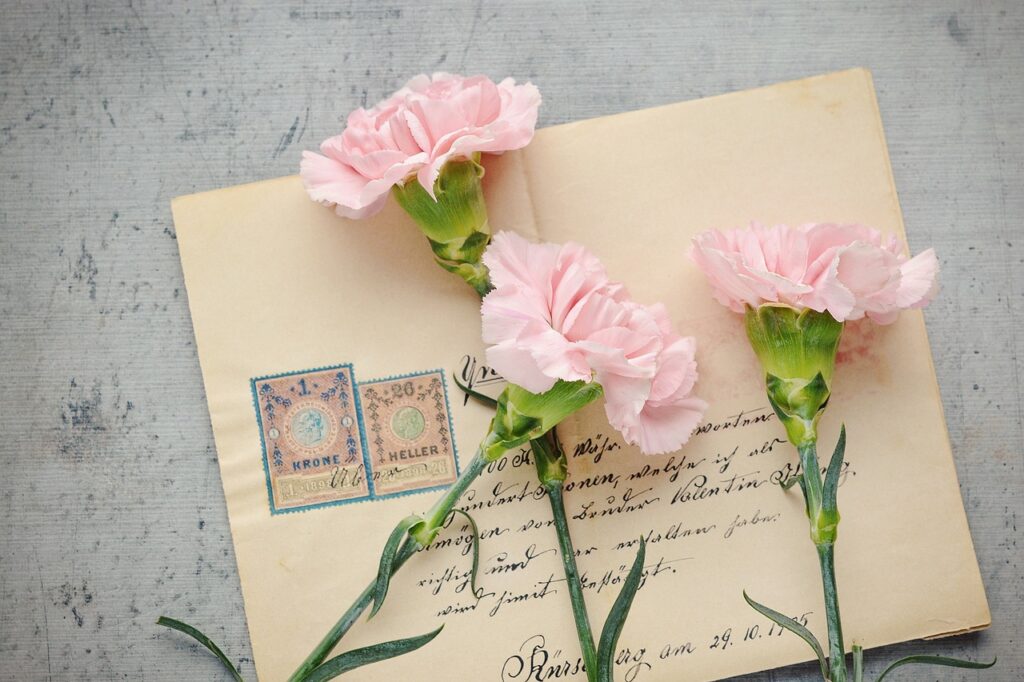 Letter, envelope, flowers, representing the technique of letter writing.