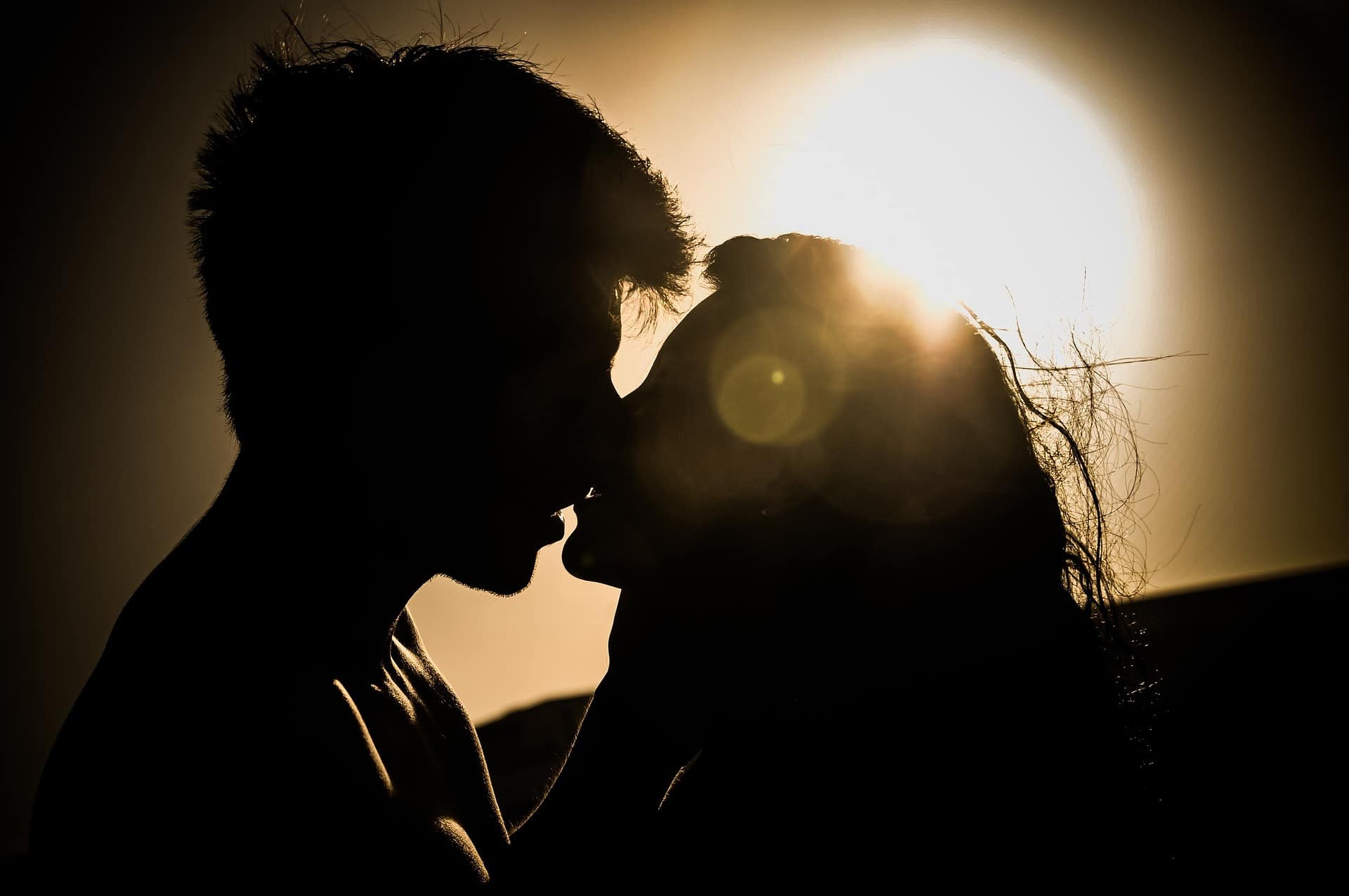Couple kissing at sunset